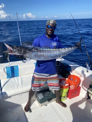Captain Lenroy with fish in hand